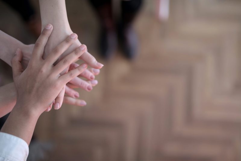 crop-group-stacking-hands-together-3830745